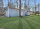 Outbuilding featuring a large shed with white trim, next to a smaller shed, all set against a grassy backyard at 114 Mcbride Rd, Fayetteville, GA 30215