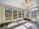 Sunroom with tile flooring, ceiling fan, and large windows, offering a bright and airy space to relax and enjoy the view at 114 Mcbride Rd, Fayetteville, GA 30215