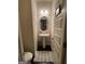 Small pedestal sink bathroom with neutral paint, wood floors and home decor at 6001 Nile Ct, Atlanta, GA 30349
