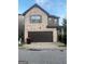 Charming two-story home with a brick and stone facade, plus an attached garage at 6001 Nile Ct, Atlanta, GA 30349