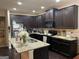 Modern kitchen features granite countertops, dark cabinets, and stainless steel appliances at 6001 Nile Ct, Atlanta, GA 30349