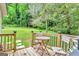 Backyard view from the deck with a lush lawn and a mature tree backdrop at 4481 Mclain Cir, Acworth, GA 30101
