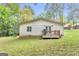 Backyard view of property with deck, lush green lawn and treed backdrop at 4481 Mclain Cir, Acworth, GA 30101