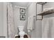 This bathroom features framed pictures and a toilet with a floral shower curtain at 4481 Mclain Cir, Acworth, GA 30101