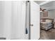 Bathroom with open door to bedroom featuring a shower with white curtain and blue soap at 4481 Mclain Cir, Acworth, GA 30101