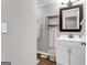 Cozy bathroom featuring a vanity with white cabinets and a dark framed mirror at 4481 Mclain Cir, Acworth, GA 30101