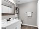 Bathroom features a white vanity with framed mirror, tile floors and a shower with white curtain at 4481 Mclain Cir, Acworth, GA 30101