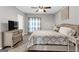 This large bedroom has neutral paint, a ceiling fan, and a TV on the wall at 4481 Mclain Cir, Acworth, GA 30101