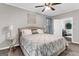 This large bedroom has neutral paint and leads to a living room with a plant at 4481 Mclain Cir, Acworth, GA 30101