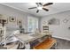 The open dining room features a ceiling fan, a long table and chairs at 4481 Mclain Cir, Acworth, GA 30101