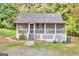 Inviting single-story home featuring a delightful screened porch with latticework and landscaped yard at 4481 Mclain Cir, Acworth, GA 30101