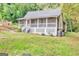 Lovely single-story home with a screened porch, surrounded by a well-manicured lawn and mature trees at 4481 Mclain Cir, Acworth, GA 30101