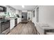 Modern kitchen with stainless steel appliances, white cabinets and new flooring, perfect for cooking and entertaining at 4481 Mclain Cir, Acworth, GA 30101