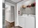Clean laundry room with washer, dryer, and storage shelf, offering convenience and functionality at 4481 Mclain Cir, Acworth, GA 30101