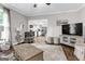Bright living room with hardwood floors leading into a modern, white kitchen with stainless appliances at 4481 Mclain Cir, Acworth, GA 30101