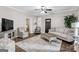 Cozy living room featuring hardwood floors, a ceiling fan and neutral color scheme, with a view to an adjacent room at 4481 Mclain Cir, Acworth, GA 30101