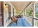 Cozy screened-in porch with wicker furniture, ceiling fan, and a view of the lush outdoors at 4481 Mclain Cir, Acworth, GA 30101