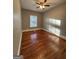 Bright bedroom showcasing hardwood floors, neutral walls and bright natural light at 18 Laurel St, Covington, GA 30014