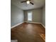 Neutral bedroom features include hardwood floors, paint, and a ceiling fan at 18 Laurel St, Covington, GA 30014
