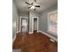 Cozy bedroom with hardwood floors, neutral paint, and access to closet and doorway at 18 Laurel St, Covington, GA 30014