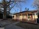 Charming home featuring a cozy front porch and freshly painted red and white trim, situated on a tree-lined lot at 18 Laurel St, Covington, GA 30014