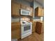 Close up of the kitchen featuring wooden cabinets, countertops and updated appliances at 18 Laurel St, Covington, GA 30014