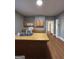 Spacious kitchen featuring an island with sink, wooden cabinets and updated appliances at 18 Laurel St, Covington, GA 30014