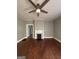 Living room with fireplace, ceiling fan, hardwood floors and gray walls at 18 Laurel St, Covington, GA 30014