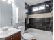Modern bathroom with dark tile, a shower and tub combination, and updated fixtures at 255 Brandon Ridge Cir, Stockbridge, GA 30281