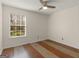 Bedroom with neutral walls, hardwood floors, and a window for natural light at 255 Brandon Ridge Cir, Stockbridge, GA 30281