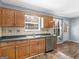 Kitchen features double sink, stainless steel dishwasher, light-wood cabinets and a door to the exterior at 255 Brandon Ridge Cir, Stockbridge, GA 30281