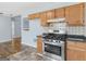 Well-lit kitchen features stainless steel stove, white tile backsplash, and light wood cabinets at 255 Brandon Ridge Cir, Stockbridge, GA 30281