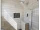 Modern walk-in shower featuring gray-tone tile and updated fixtures, along with a bench at 255 Brandon Ridge Cir, Stockbridge, GA 30281