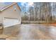 Spacious backyard featuring a basketball court and a two-car garage at 65 Ashland Grove Ct, Sharpsburg, GA 30277