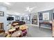 Basement rec room with a drum set, sports memorabilia, and a comfortable seating area at 65 Ashland Grove Ct, Sharpsburg, GA 30277