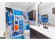 bathroom with 'Minecraft' shower curtain, blue towels, vanity, mirror, and toilet at 65 Ashland Grove Ct, Sharpsburg, GA 30277