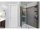 Modern bathroom with glass enclosed shower featuring tiled walls, white shower base, and bathroom door at 65 Ashland Grove Ct, Sharpsburg, GA 30277