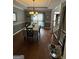 Elegant dining room with traditional chandelier and large window, creating a warm, inviting atmosphere at 65 Ashland Grove Ct, Sharpsburg, GA 30277
