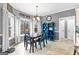 Eat-in dining room with hardwood floors, bright windows, and stylish decor at 65 Ashland Grove Ct, Sharpsburg, GA 30277