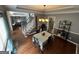 Bright dining room open to stairs with stylish chandelier and hardwood floors at 65 Ashland Grove Ct, Sharpsburg, GA 30277