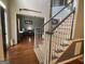 Bright foyer with hardwood floors, staircase, and view to the formal living room at 65 Ashland Grove Ct, Sharpsburg, GA 30277