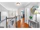 Upstairs hallway with hardwood floors and a view to the entry foyer at 65 Ashland Grove Ct, Sharpsburg, GA 30277