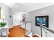Hallway featuring hardwood floors, white railing, closet, picture, hanging light fixture and plant at 65 Ashland Grove Ct, Sharpsburg, GA 30277