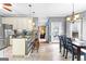Open kitchen featuring a breakfast bar, pendant lighting, and dining room view at 65 Ashland Grove Ct, Sharpsburg, GA 30277