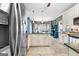 Well-lit kitchen with granite countertops, travertine floors, and stainless steel appliances at 65 Ashland Grove Ct, Sharpsburg, GA 30277