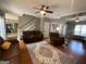 Living room featuring hardwood floors and comfortable brown seating at 65 Ashland Grove Ct, Sharpsburg, GA 30277