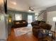 Living room with hardwood floors, a fireplace, and access to the back deck at 65 Ashland Grove Ct, Sharpsburg, GA 30277