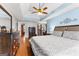A luxurious main bedroom with tray ceilings, wooden floors, and a large bed at 65 Ashland Grove Ct, Sharpsburg, GA 30277