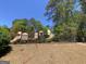 Community playground featuring colorful slides, climbing structures, and safety fencing amidst a natural setting at 65 Ashland Grove Ct, Sharpsburg, GA 30277
