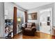 Cozy sitting area with a leather armchair, wood floors, a window, and an ensuite bath at 65 Ashland Grove Ct, Sharpsburg, GA 30277